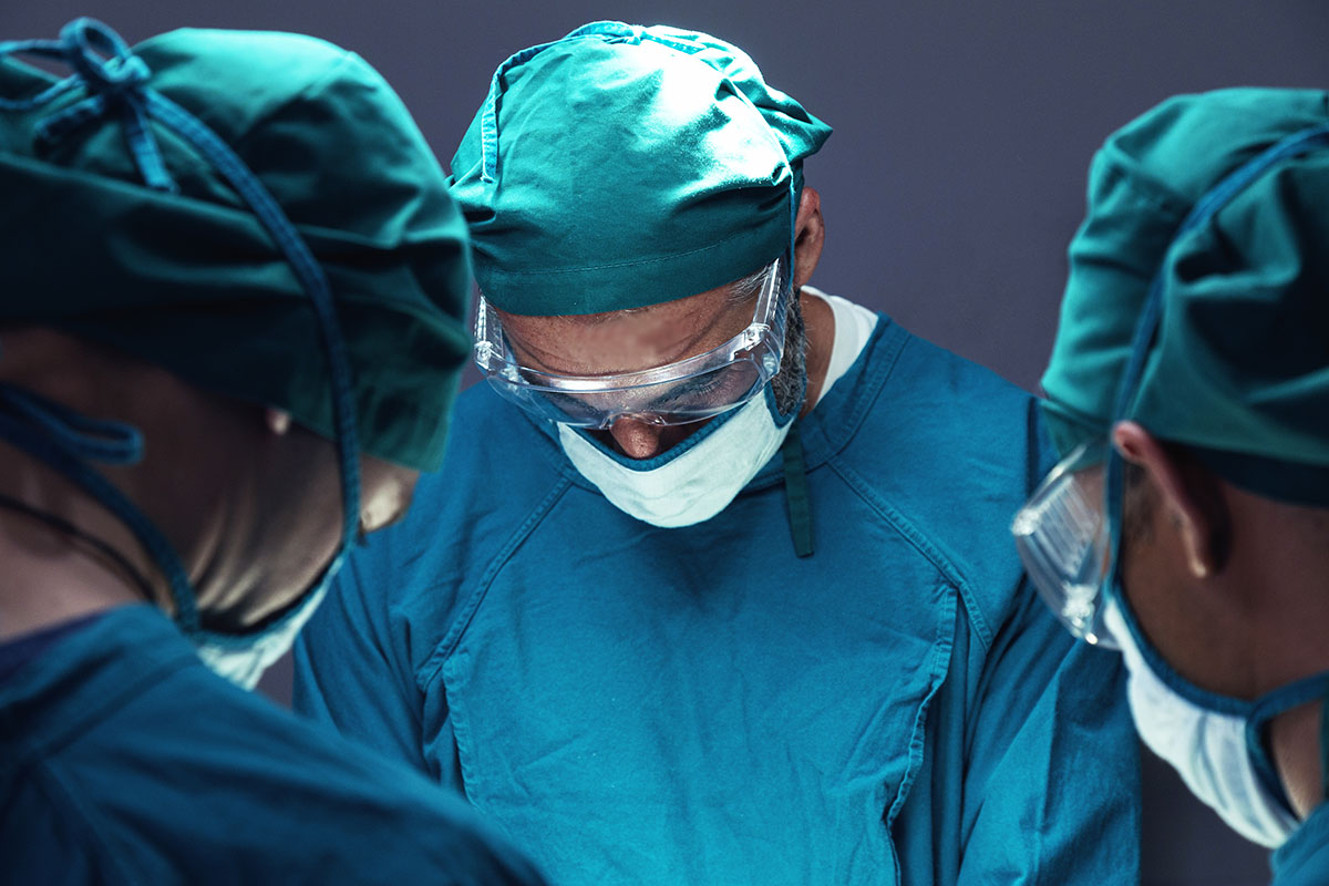 spine trauma surgeon operating on patient