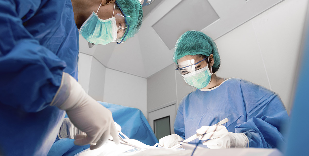 two BSSNY plastic surgeons performing procedures on a patient