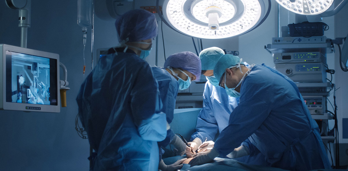 surgeons operating on a patient with Degenerative Disc Disease