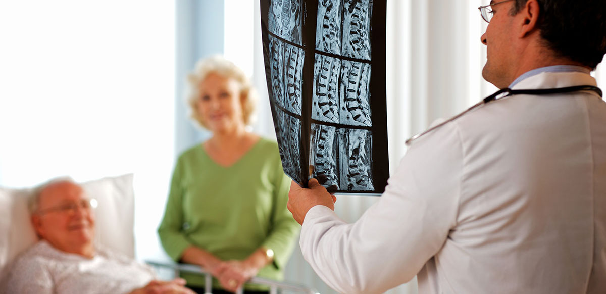 neurosurgeon examining an x-ray for procedures